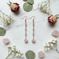 Copper linear chain rose quartz earrings white marble flat lay