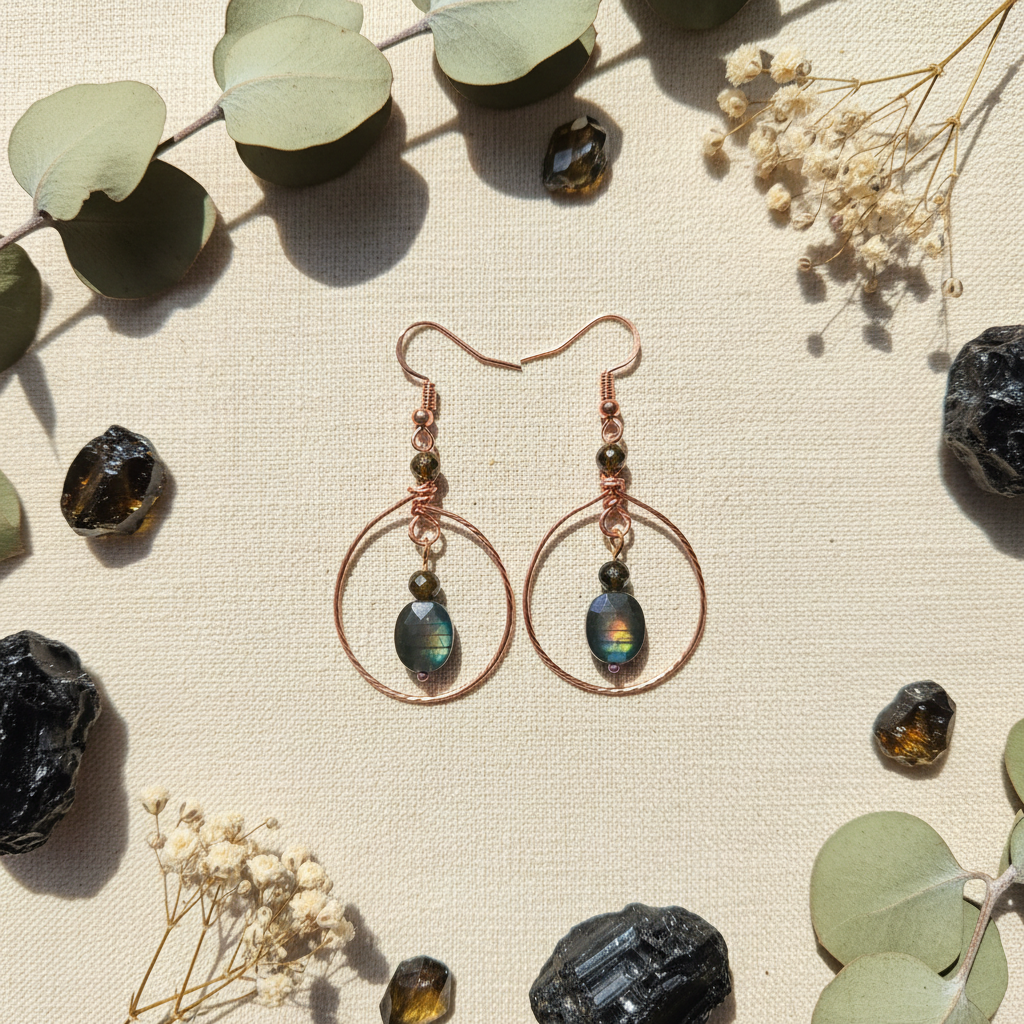Copper hoop obsidian earrings cream linen flat lay
