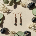 Copper stacked obsidian earrings cream linen flat lay
